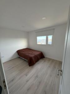 ein Schlafzimmer mit einem Bett und einem Fenster in der Unterkunft Dúplex barrio Aeropuerto in Río Grande