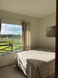 a bedroom with a bed and a large window at Condomínio Villa das Águas Litoral Sul de Sergipe in Estância +25 photos