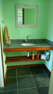 a bathroom with a sink and a mirror at Aconchego in Paraty