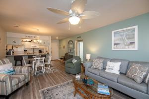 a living room with a couch and a table at Club Cottage 824 - CLARITY in Edisto Beach