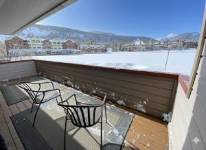 two chairs on a balcony with snow on the ground at Argentine 1504 by SummitCove Lodging in Colorado in Keystone