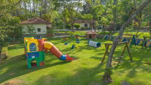 a park with a playground with a slide and swings at B Homy Hotel Fazenda APM in Caieiras