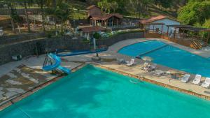 an overhead view of a swimming pool with a slide at B Homy Hotel Fazenda APM in Caieiras