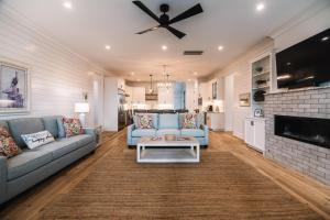 a living room with a blue couch and a fireplace at Glory Be in Edisto Island
