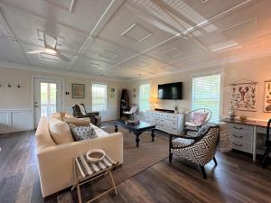 a living room with a couch and a table at Serenity Now in Edisto Island