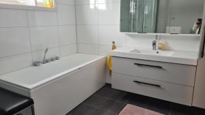 a white bathroom with a sink and a mirror at Feriehuset Holmen in Straumen +23 photos