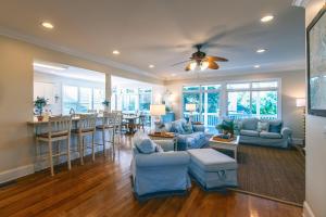 a living room with blue furniture and a bar at I'll Have Another in Edisto Island