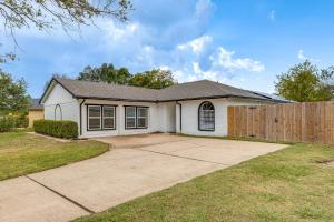 a white house with a wooden fence at Families Welcome! Recently Renovated Home in Katy in Katy