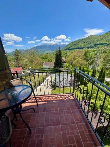 a patio with a table and a chair on a balcony at Oana Boutique C D I in Bran