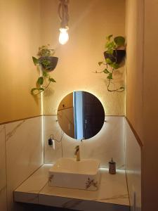 a bathroom with a sink and a mirror at Sonho Meu in Itapoa
