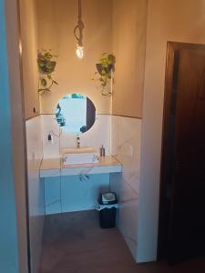 a bathroom with a sink and a mirror at Sonho Meu in Itapoa