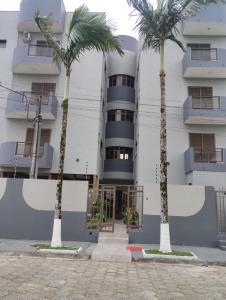 MatinhosにあるEnsolarado apto com vista para o marの前にヤシの木がある建物