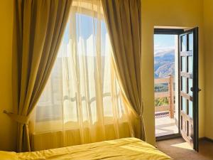 a bedroom with a bed and a large window at Pensiunea Casa Ancutei in Ranca +53 photos