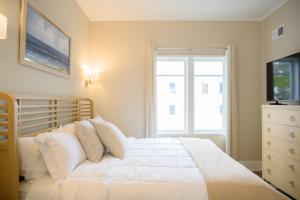 a bedroom with a white bed and a window at Coastal Luxury Studio One Block to Big Rock in Morehead City