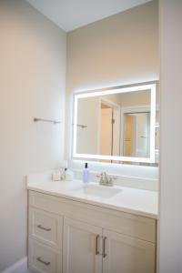 a bathroom with a sink and a mirror at Coastal Luxury Studio One Block to Big Rock in Morehead City