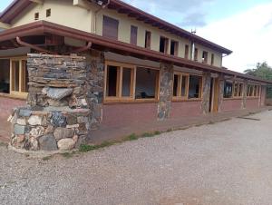 a large building with a stone pillar in front of it at Agriturismo Conca del Re in Castrovillari