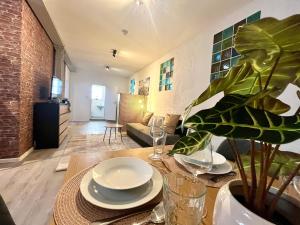 a living room with a table with plates and a plant at Industrial feeling in a quiet location in Leipzig +19 photos