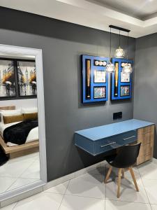 a bedroom with a blue desk and a bed at 98 Inn Guesthouse Two Bedroom Apartment in Jacksonʼs Drift