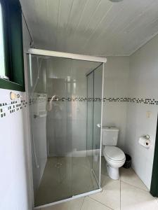 a bathroom with a shower and a toilet at Bangalô Bambu in Imbituba +16 photos
