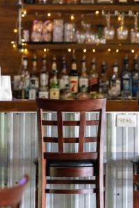 a wooden chair in front of a bar with alcohol bottles at Avoca Room at The Inn, Occano Arnold Palmer Golf Course 