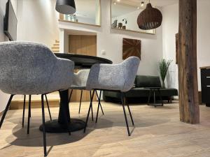 a living room with a piano and chairs at Le Marzelheide 2 in Lontzen