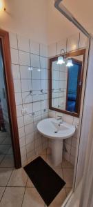 a bathroom with a sink and a mirror at Agriturismo Conca del Re in Castrovillari
