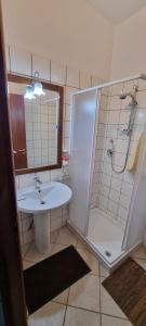 a bathroom with a sink and a shower at Agriturismo Conca del Re in Castrovillari