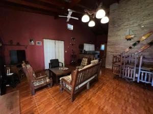 a living room with a couch and a table at Hermoso Chalet con pileta frente al rio in Paso de la Patria
