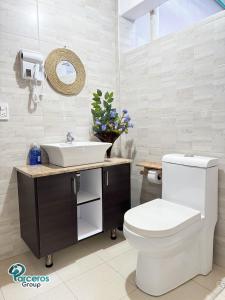 ein Badezimmer mit einer weißen Toilette und einem Waschbecken in der Unterkunft Apartamentos Zona Circunvalar Por Parceros Group in Pereira