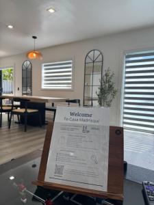 a welcome sign in front of a living room at Casa Madrisqui in Homestead