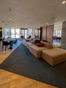 a living room with a long couch and a table at Skylux 1608, 2008 e 2828 in Rio de Janeiro