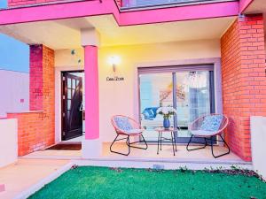 een terras met twee stoelen en een tafel op een huis bij Beach House in Fão