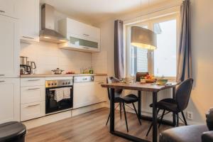 a kitchen with a table and chairs in a kitchen at Fünf Harzer Berge Oderberg in Sankt Andreasberg