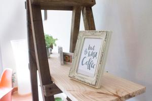 a wooden shelf with a picture frame on a table at Departamentos Arrayán in Puerto Montt