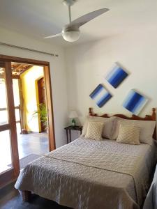 Schlafzimmer mit einem Bett mit blauen Gemälden an der Wand in der Unterkunft Suítes em Casa linda na Serra Paty do Alferes Rj in Paty do Alferes + 50 Fotos
