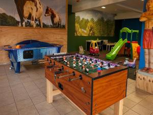 a foosball table in the middle of a childs play room at Villa in Friesland with Garden by Water in Andijk
