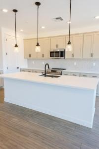 a white kitchen with a large white counter top at Modern Private Room with Private Bath in Manteca