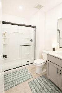 a bathroom with a shower and a toilet and a sink at Modern Private Room with Private Bath in Manteca
