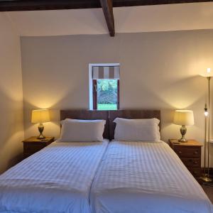 a bedroom with two beds and a window at Lodge Barns in Fiskerton