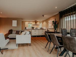 a living room with a couch and a table and chairs at Houseboat in Netherlands with Private Dock in Uitgeest