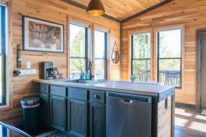 a kitchen with a sink and a counter top at Bourbon Barrel Cottages #2 of 5 on Kentucky trail in Lawrenceburg +5 photos