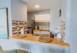 a kitchen with a counter with two baskets on it at Marena Seaview Condo in Dos Marinas, Fajardo in Beltran