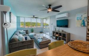 a living room with a couch and a table at Marena Seaview Condo in Dos Marinas, Fajardo in Beltran