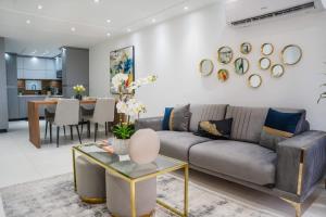 a living room with a couch and a table at Isla | The Sunset Abode in Ocean Club, Rincón in Corcega