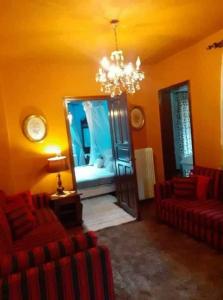 a room with two red chairs and a mirror at Meteora best view villa in Kalabaka