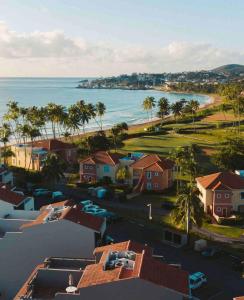 an aerial view of a beach with houses and the ocean at Selah | Travelers Nesters in Palmas Del Mar in Buena Vista
