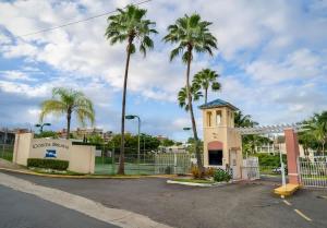 a building with palm trees in a parking lot at Serenity | Beach Vibe stay in Costa Brava, Ceiba in Santa Maria