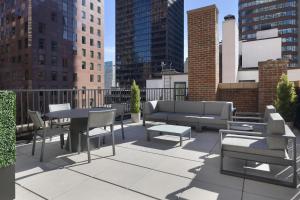 a rooftop patio with tables and chairs and buildings at Residence Inn by Marriott New York Manhattan/ Midtown Eastside in New York