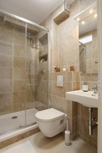 a bathroom with a shower and a toilet and a sink at Contarini Apartment in Split +39 photos