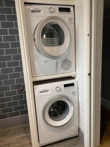a washing machine and a washer and dryer in a bathroom at Gorgeous Town Centre 3-Bed 2-Bath Apartment Parking Available in Harrogate